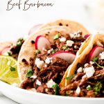 A close up shot of tacos with Beef Barbacoa meat, radishes, cilantro, and cheese.