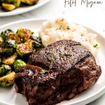 Filet Mignon, brussels sprouts, and mashed potatoes on a plate.