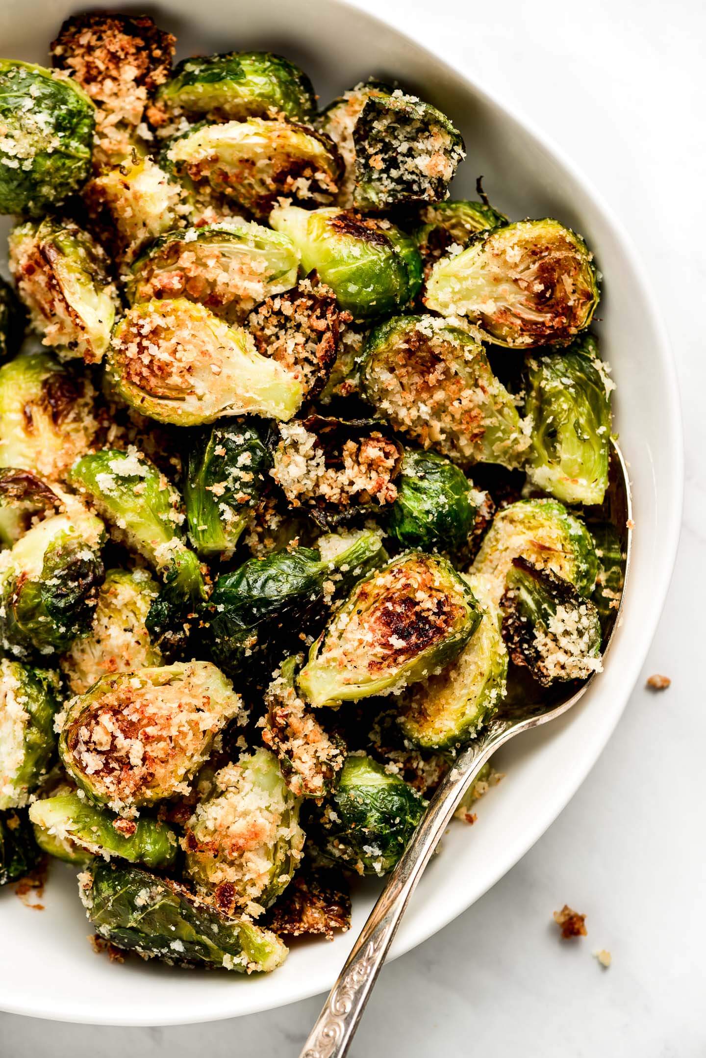 A large serving bowl of Parmesan Brussels Sprouts.