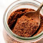 Close up shot of Taco Seasoning on a spoon in a jar.