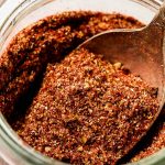 Close up shot of Taco Seasoning on a spoon in a jar.