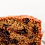 Cross section of zucchini bread studded with chocolate chips.