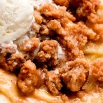 Close up shot of crispy streusel on baked apple slices.