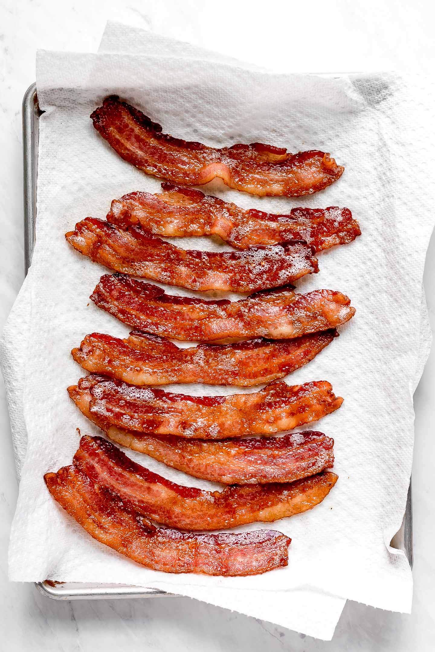 A paper towel lined pan of Baked Bacon Strips.