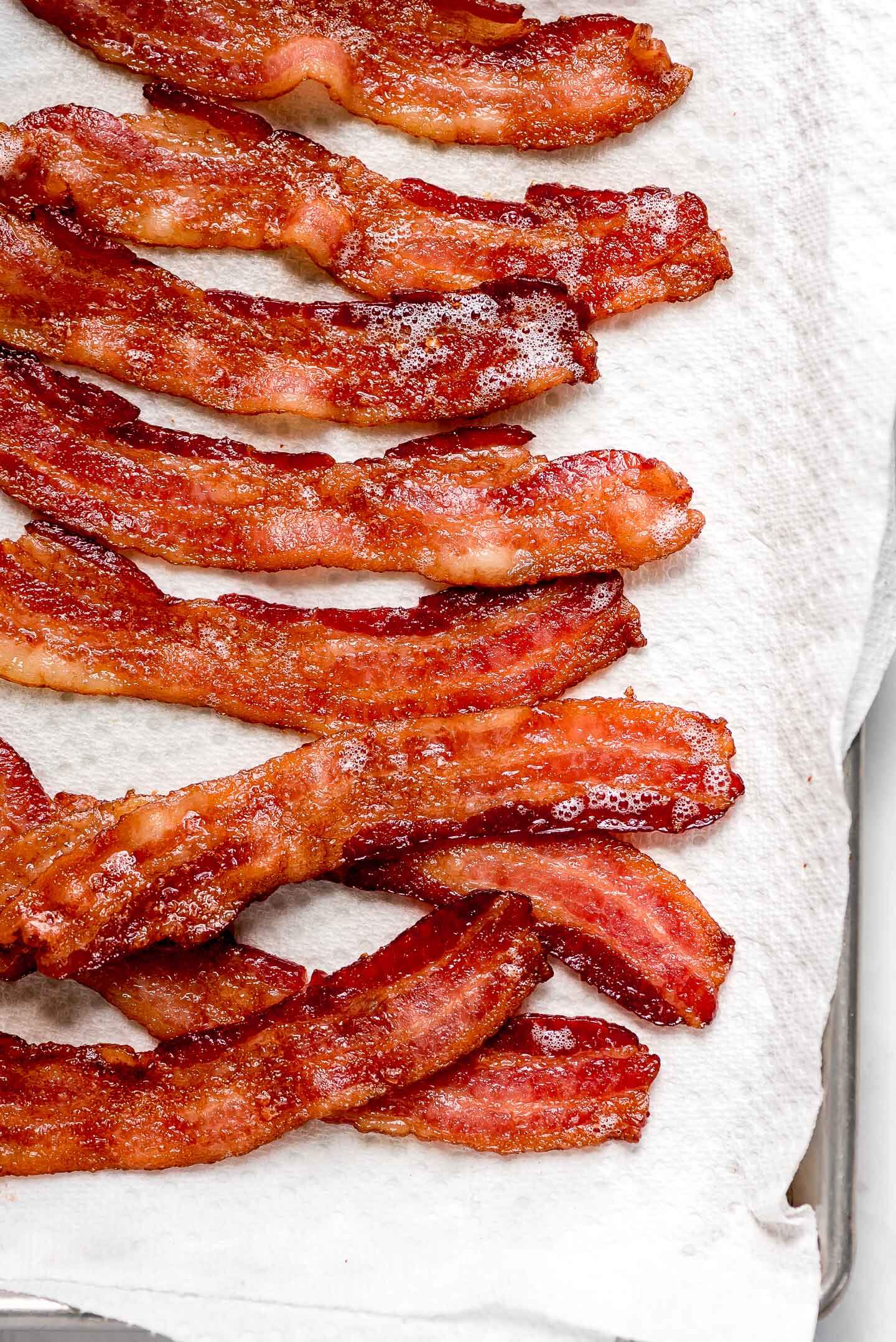 Strips of Oven Baked Bacon on a paper towel lined pan.