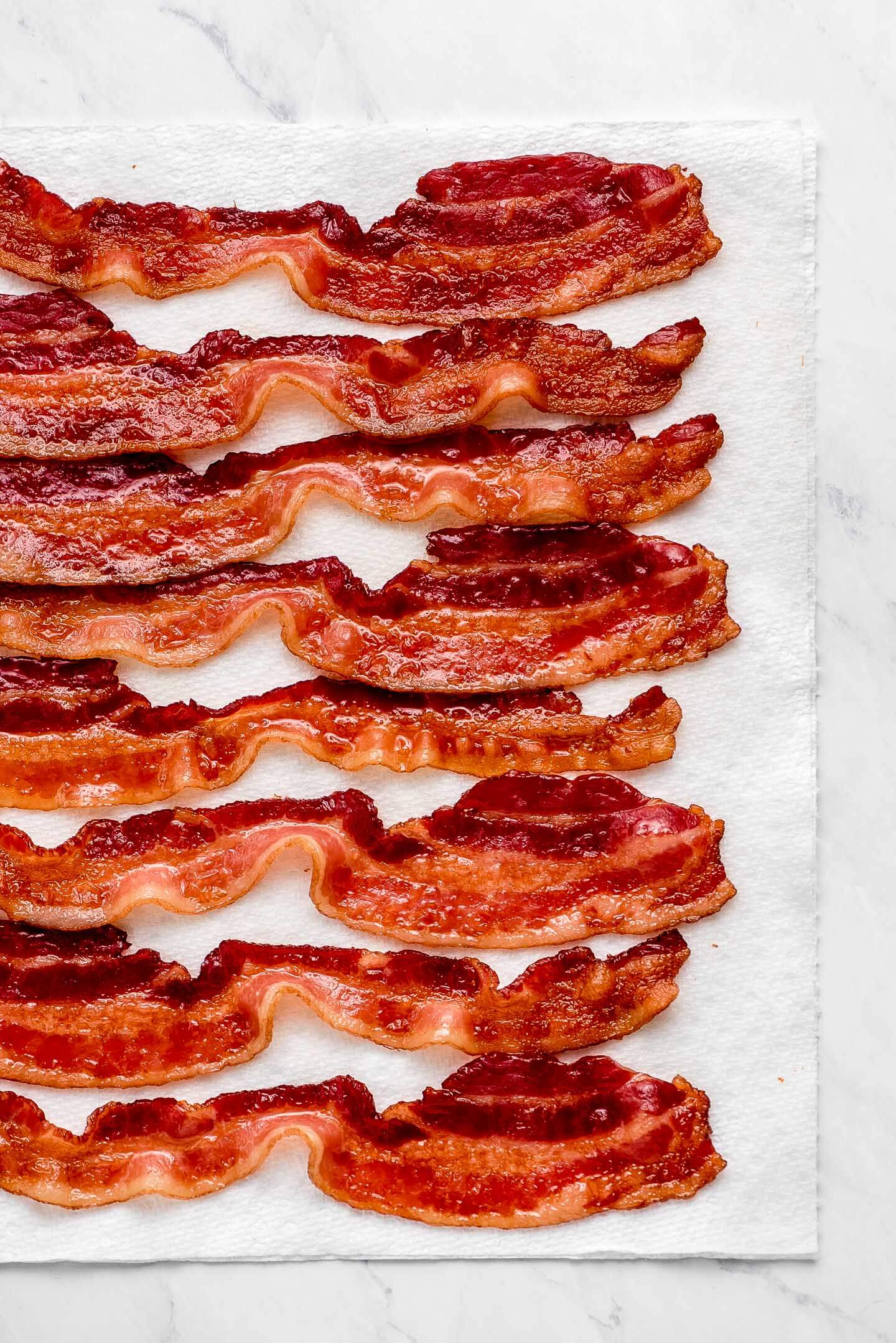 Sliced of Baked Bacon on a paper towel.