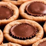 A close up 45 degree angle view of a Reese's in a cookie.