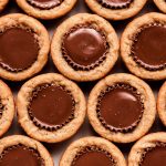 Top view of many Peanut Butter Cup Cookies pressed close to each other.