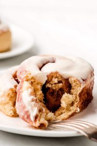 A Cinnamon Roll cut open to show the fluffy soft interior.