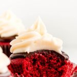 Red Velvet Cupcake with a bite taken out showing the fluffy texture.