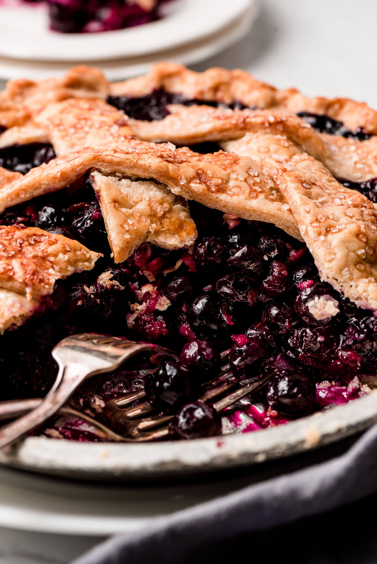 Close up shot of the filling of a blueberry pie with a lattice top.