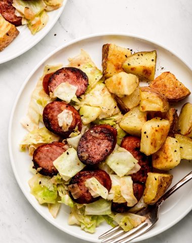 Cabbage and Sausage on a plate with crispy potatoes.