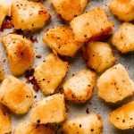 Crispy potatoes on a baking sheet.