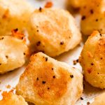 Close up of crispy potatoes on a sheet pan.