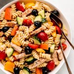 A large serving bowl of Chicken and Vegetable Pasta salad.