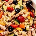 A large serving bowl of Chicken and Vegetable Pasta salad.