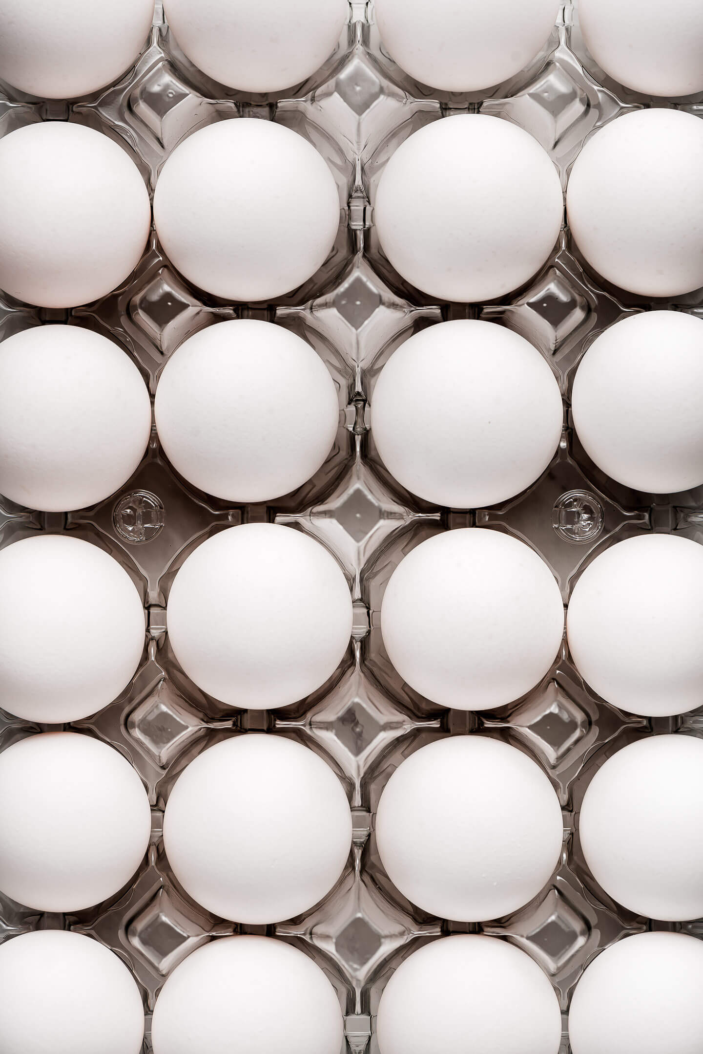 Many eggs in an egg carton.