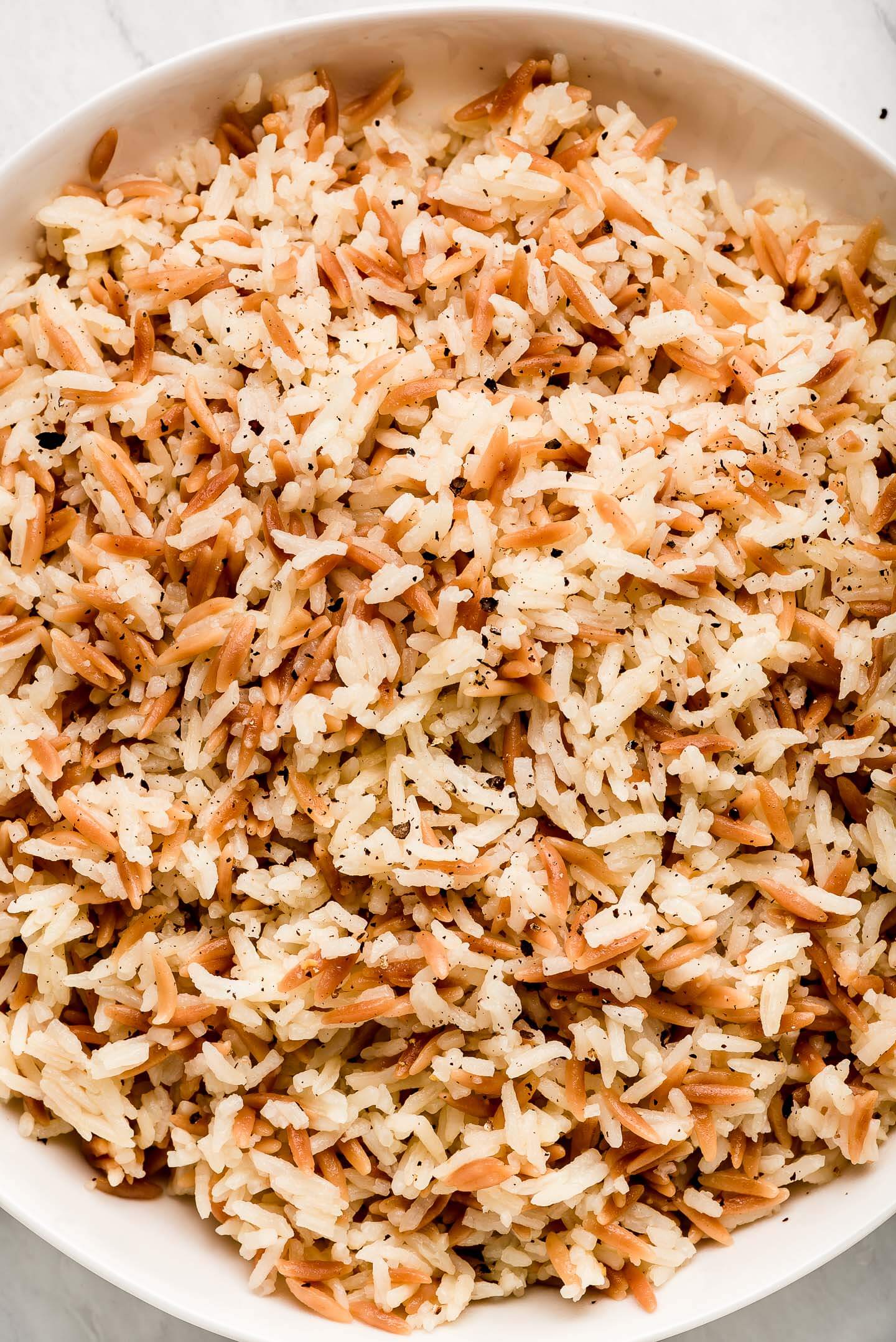 A close up shot of Orzo Rice with black pepper.