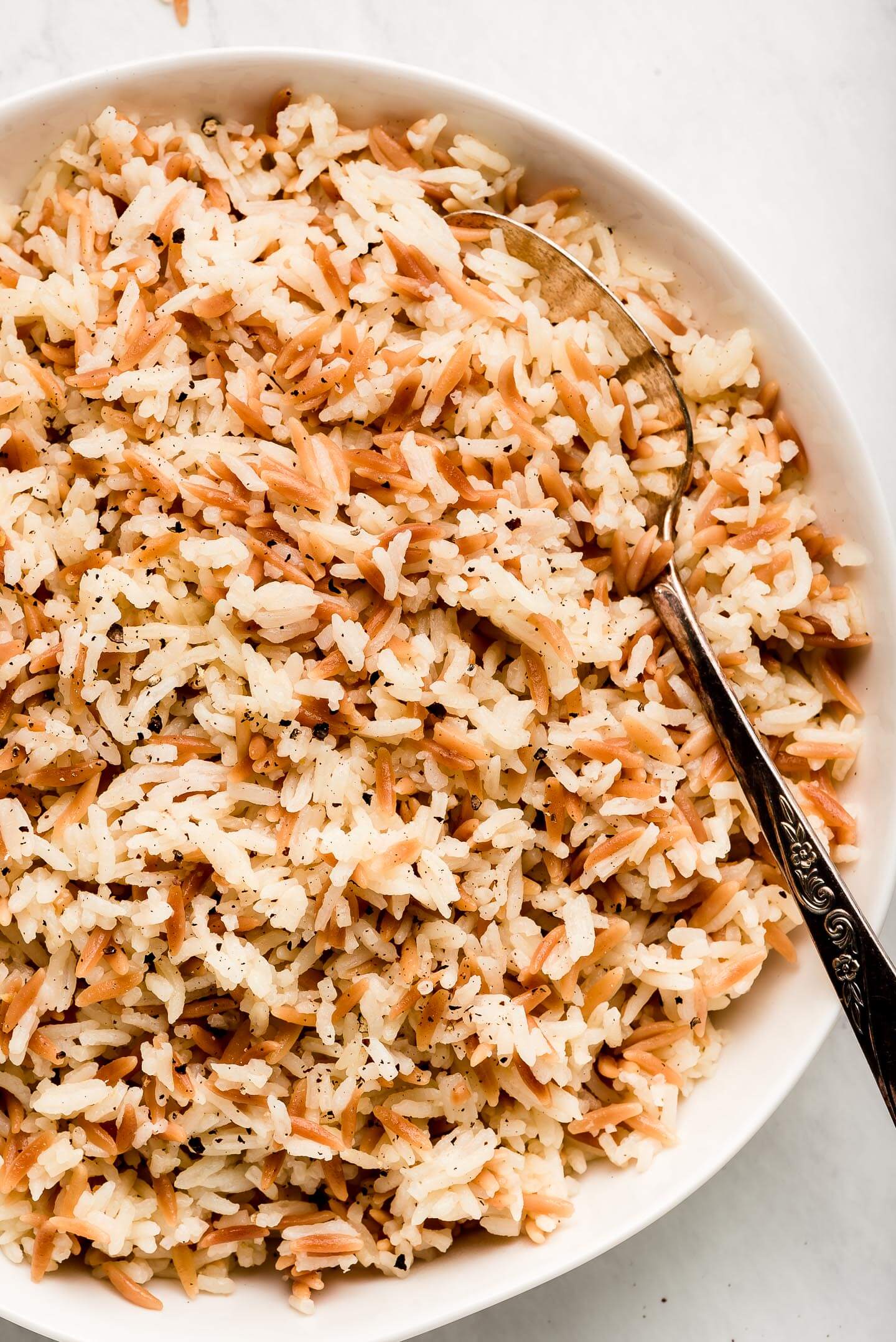 Top view of a bowl of Orzo Rice in a serving bowl.