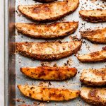 Baking sheet full of oven cooked French fries.