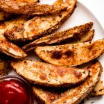 Crispy Baked Potato Wedges on a plate with ketchup.