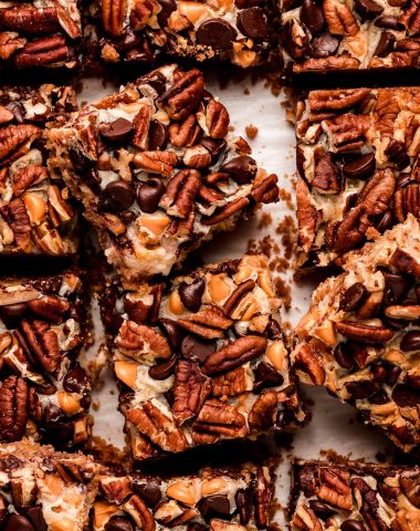 Square bars topped with chocolate chips, nuts, and butter scotch chips.