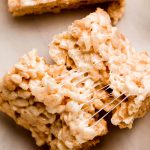 Close up of a Rice Krispie Treat with stretched gooey marshmallow.