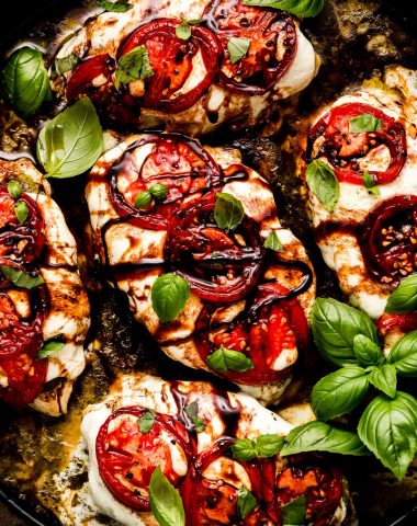 Chicken covered in mozzarella cheese and topped with tomatoes, basil, and balsamic glaze.