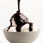 Pouring Chocolate Sauce over scoops of ice cream in a bowl.