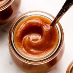 Close up of a swirl of apple butter in a jar.