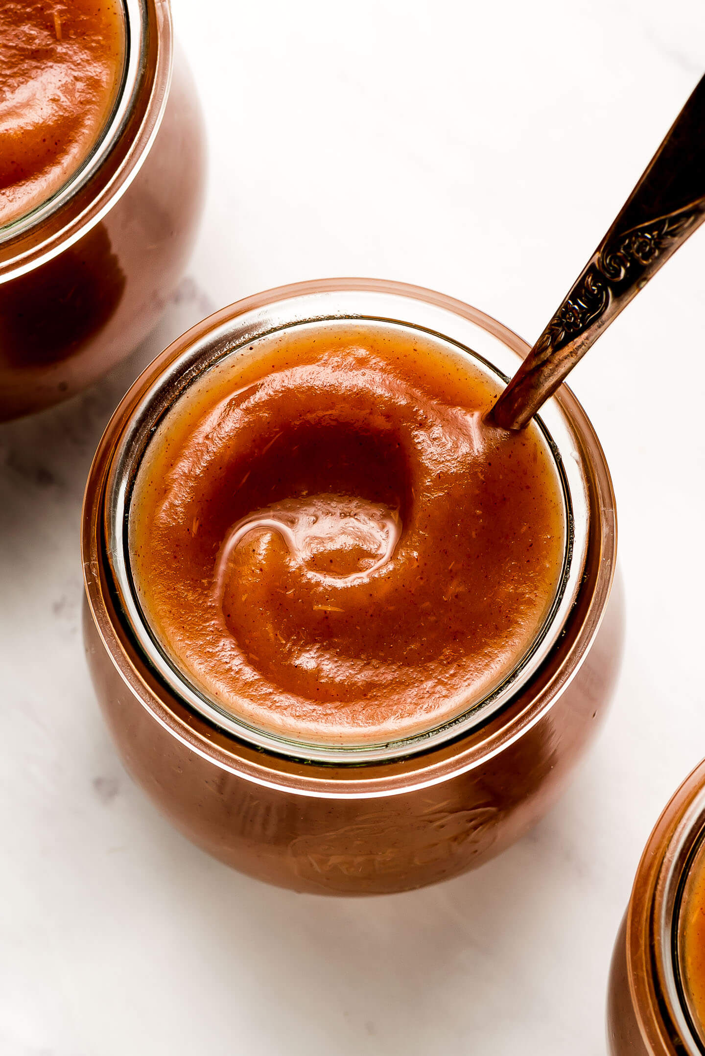 Close up of a swirl of apple butter in a jar.