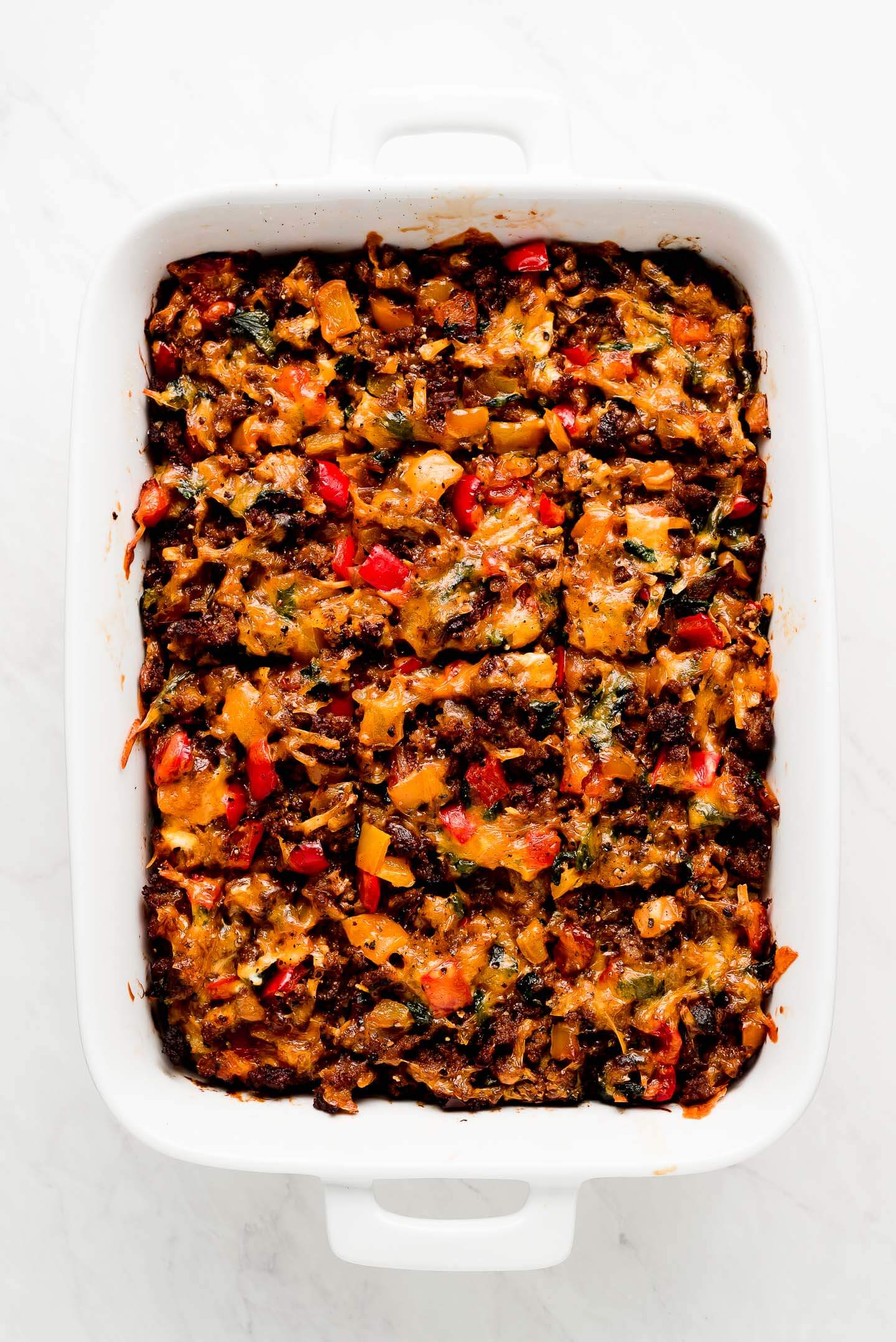 Full dish of Sausage Breakfast Casserole cut in squares.