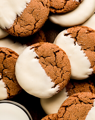 Gingersnap cookies halfway dipped in white chocolate.
