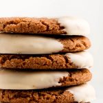 A tall stack of white chocolate dipped gingersnap cookies.
