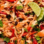 Close up of Chicken Pad Thai garnished with cilantro and peanuts.