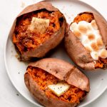 Baked Sweet Potatoes garnished with various toppings.