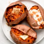 Baked Sweet Potatoes garnished with various toppings.