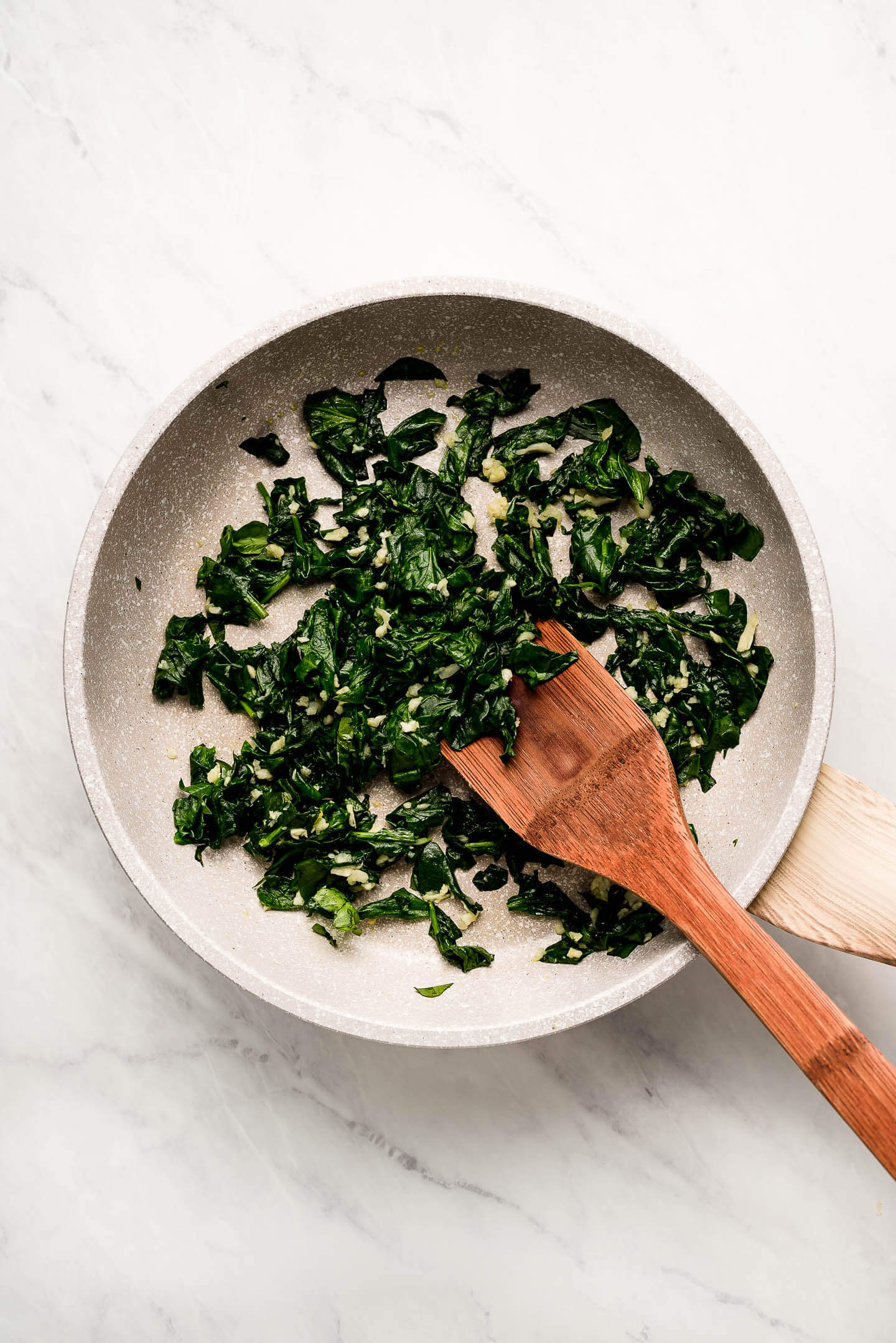 Sautéed spinach and garlic in a skillet.